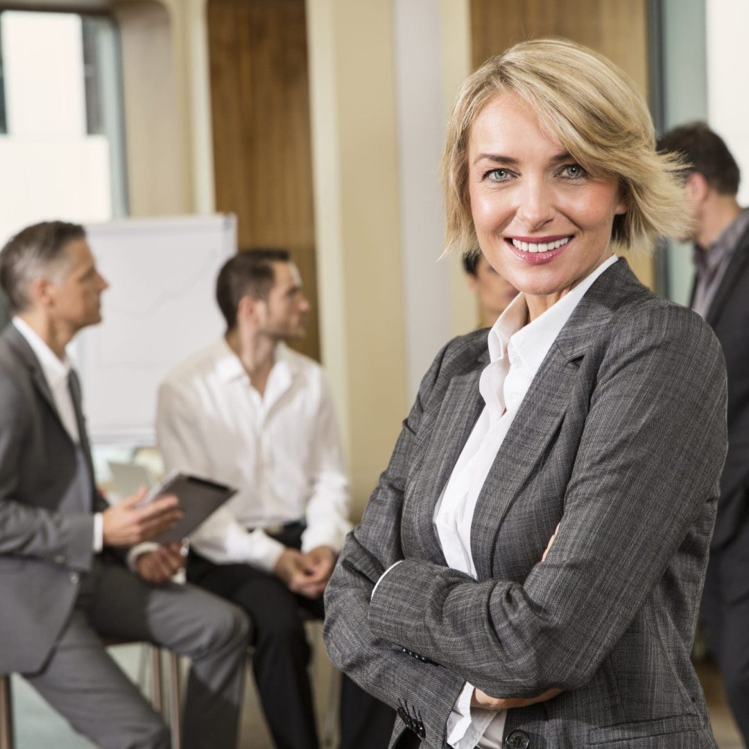 Businesswoman standing in front of colleagues