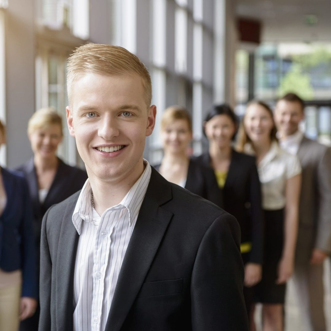 Portrait of businessman and business team standing in a row