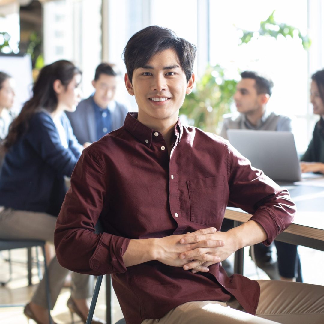 Young abroad student and his classmates in background